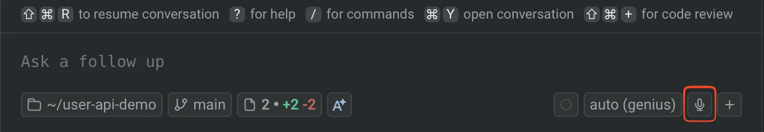 Warp input area showing the microphone icon for voice transcription